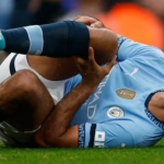 photo of footballer holding his knee in pain following an ACL injury